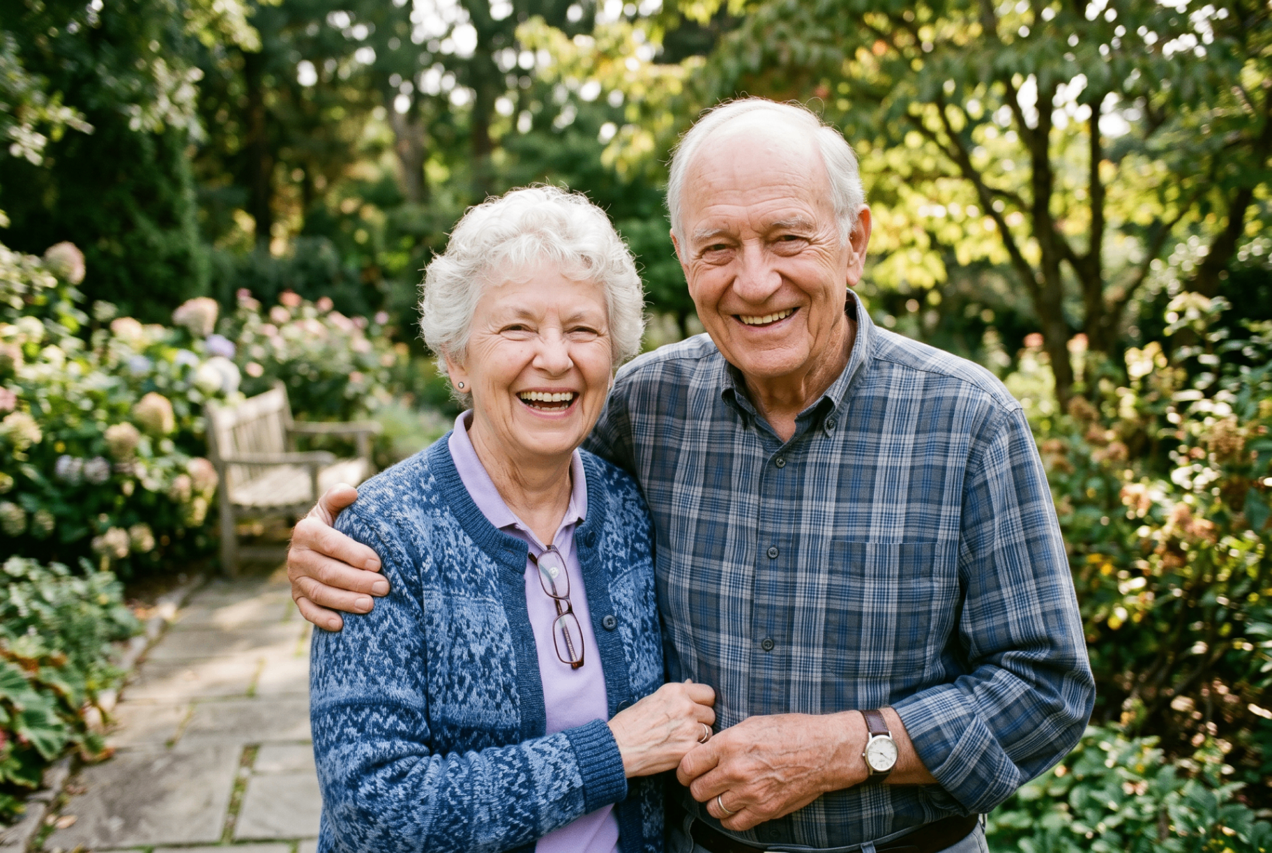 A happy older couple smiling together in a garden